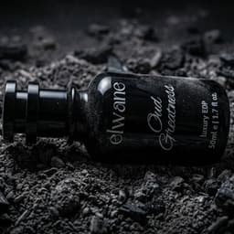 Elvare Oud Feathers perfume bottle on a dark, textured surface