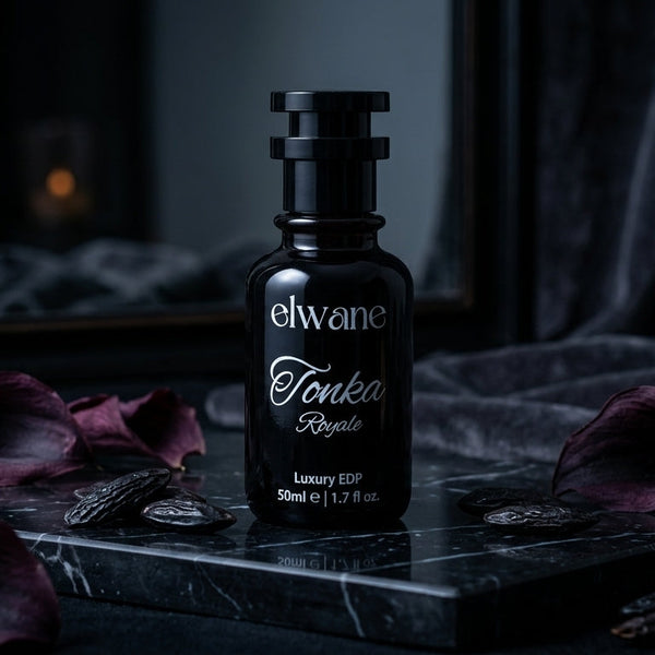 Elwane Tonka Royale perfume bottle on a dark surface with purple flowers.